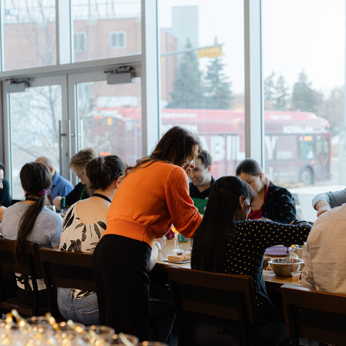 Guests chopping and cooking together during a hands-on class at Stirring It Up in Calgary